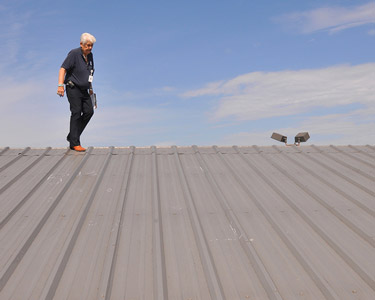 An inspector checking the roof on a commercial building.