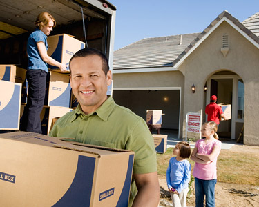 A happy family moving into their new home.